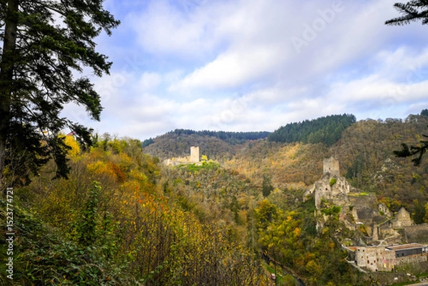 Obraz View of the autumn landscape and the Manderscheid Castles near the Eifel town of Manderscheid. Two castle ruins in the forest.
