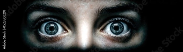 Fototapeta Panic attack by managing stress and fear concept. Intense gaze revealing emotions and thoughts in dark surroundings.
