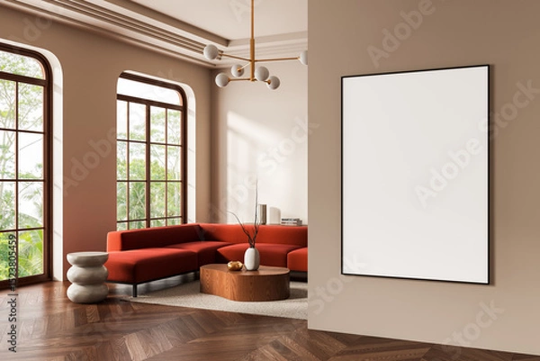 Fototapeta Modern interior with blank poster on beige wall in stylish living room featuring red sofa, wooden accents, and large windows with natural view. 3D Rendering