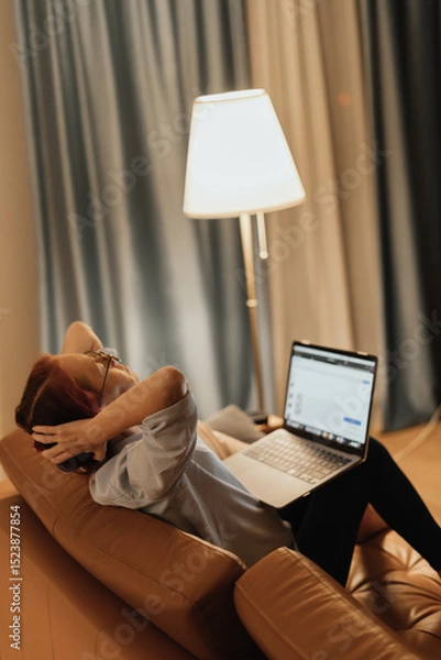 Fototapeta Woman suffers from tech neck and digital eye strain while working from home on laptop reflecting modern health issues caused by prolonged screen exposure and poor digital ergonomics