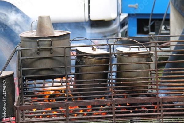 Obraz Large Food Cooking Pots on an Open Air Coal Fire.