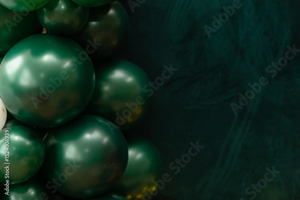 Fototapeta Elegant green and dark green balloons on a textured dark emerald green background. Perfect for celebrations, parties, or design backdrops with a luxurious feel.