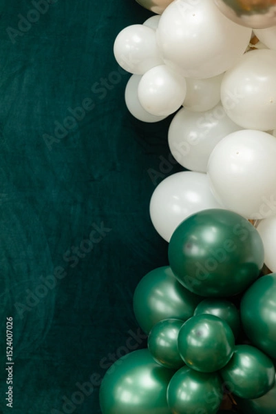 Fototapeta Elegant green and dark green balloons on a textured dark emerald green background. Perfect for celebrations, parties, or design backdrops with a luxurious feel.