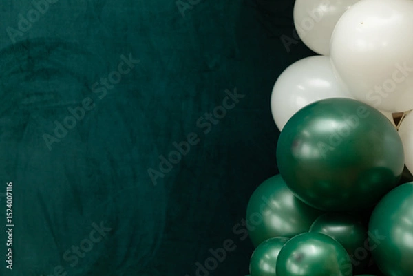 Fototapeta Elegant green and dark green balloons on a textured dark emerald green background. Perfect for celebrations, parties, or design backdrops with a luxurious feel.