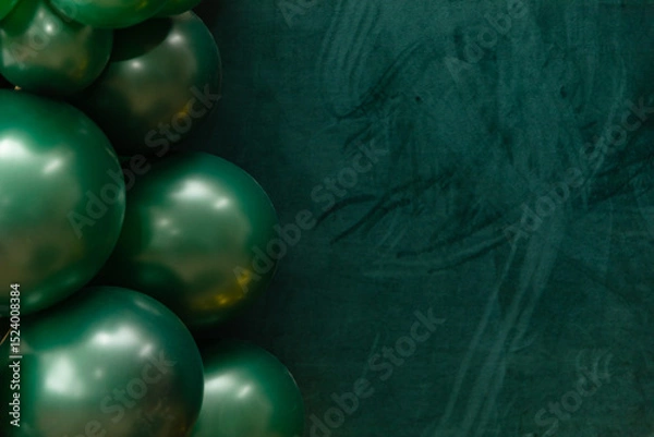 Fototapeta Elegant green and dark green balloons on a textured dark emerald green background. Perfect for celebrations, parties, or design backdrops with a luxurious feel.