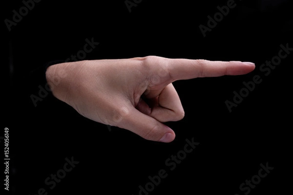 Obraz Female hand of caucasian woman pointing fingers to the right side on black background