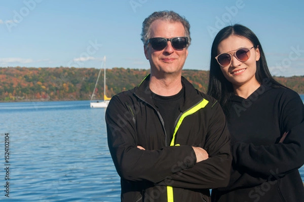 Obraz a couple with crossed arms in front of Cayuga lake new york