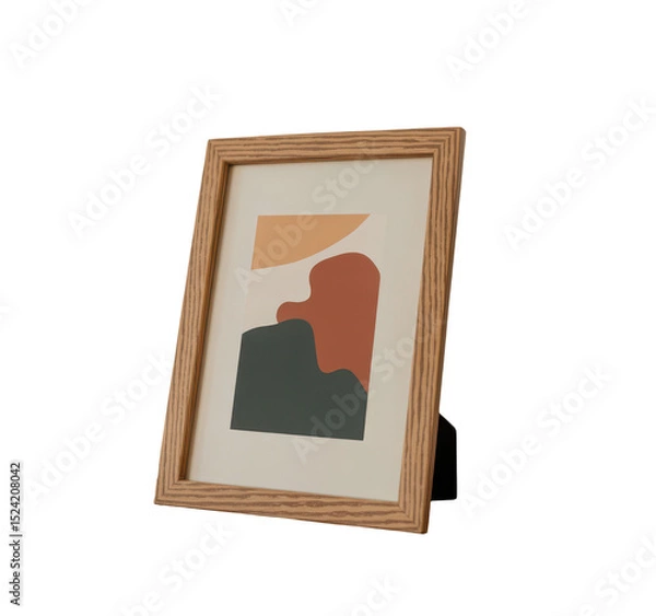 Fototapeta Realistic wooden photo frame with abstract art print standing upright with angled shadow on clean white wall, Isolated Transparent Background