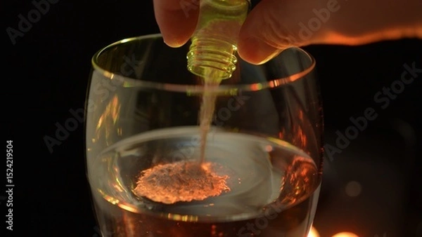 Fototapeta Club cocktail in the disco party get drugged. Putting drugs in drink at the bar. Strange unknown medicine powder falling down in glass with adult drink. Drink spiking.