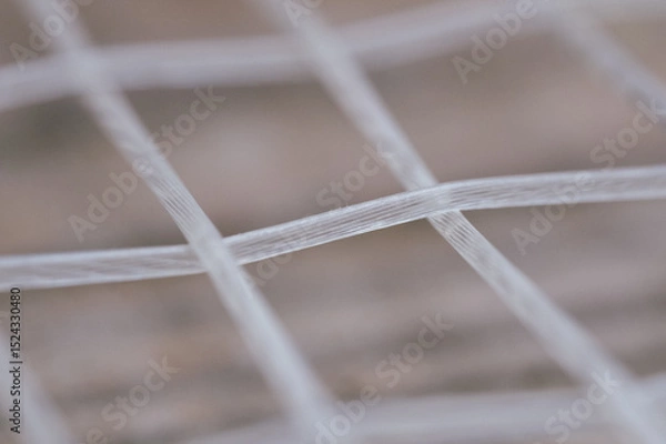 Fototapeta Extreme Close-up detail macro shot of a tennis racquet's strings. Sports Equipment. Ball Sport and Game concept. Depth of field.