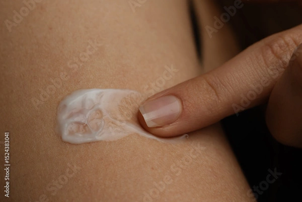 Fototapeta Applying Moisturizing Cream on Skin with Gentle Touch