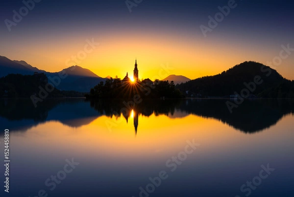 Obraz Beautiful sunset over Lake Bled with church silhouette and mountains in the background