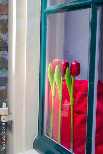 Fototapeta Symbolic plastic tulips on the windowsill of a house in Deventer, Netherlands. High quality photo
