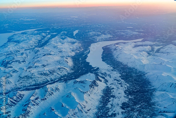 Fototapeta Aerial view of snow mountain and frozen river in colorful morning sunlight in Alaska
