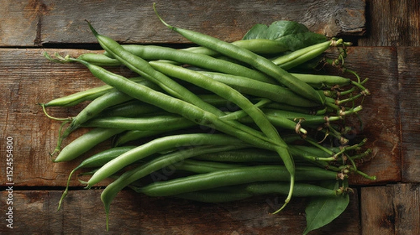 Obraz Freshly harvested green beans on a vintage and aged wooden table. Farm to kitchen produce or homegrown vegetables.
