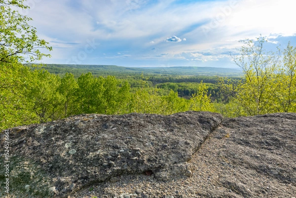 Fototapeta View from rock formation in the place of ancient prehistoric ocean trench, nestled within a green forested environment. Rim rocks formation, Western Canada Sedimentary Basin, Alberta