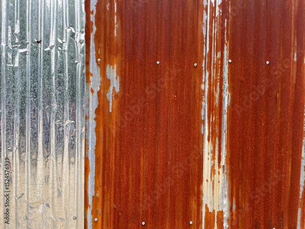 Fototapeta Background of corrugated zinc sheet with some of its surface rusted