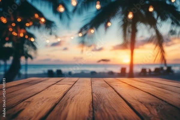 Obraz Wooden table top overlooking a beach at sunset.