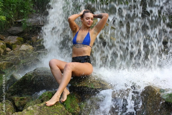 Obraz Girl in bikini under small waterfall.