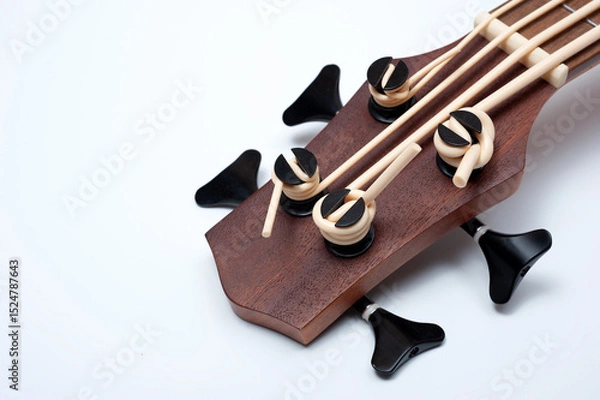 Obraz Four-string bass ukulele with wooden body and built-in tuner and pickup.