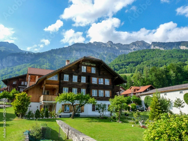 Obraz Switzerland, Meiringen, a building with a mountain in the background
