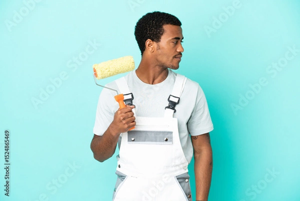 Obraz African American painter man over isolated blue background looking to the side