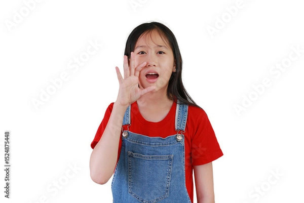 Obraz Portrait of Asian young girl with hand cupped to his mouth and shouting or whispering an exciting secret, on white background.