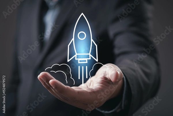 Fototapeta A business professional holds a hand up with a graphic of a rocket, symbolizing innovation, technology, and ambition.
