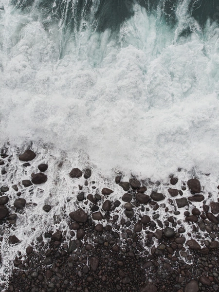 Fototapeta Aerial View of Ocean Waves and Rocky Shoreline