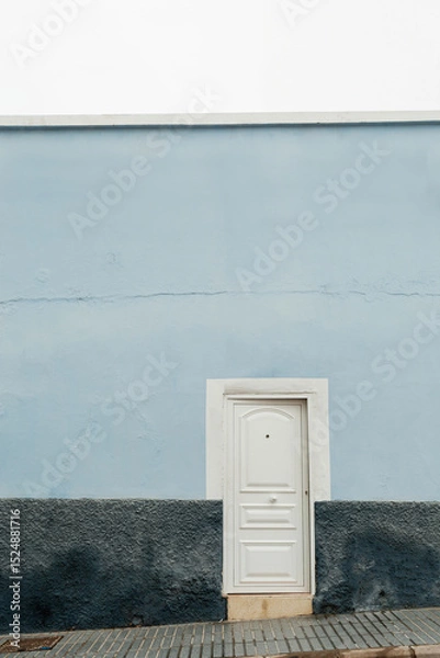 Fototapeta White Door on Minimal Light Blue Wall