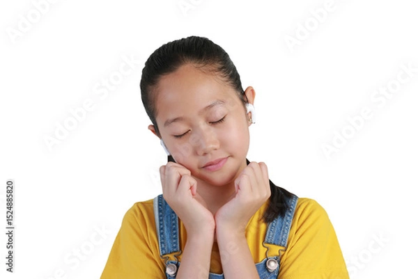 Obraz Portrait Asian girl using wireless headphones enjoy with music isolated on white background. Close up shot.