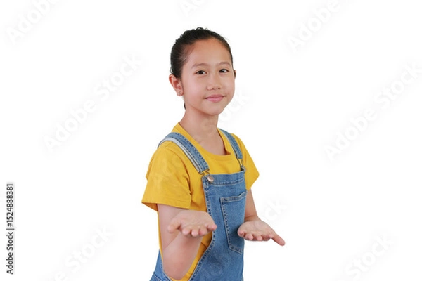 Obraz Portrait of Asian girl child smiling and welcoming you gesture against white background isolated. Kid showing a welcome expression.