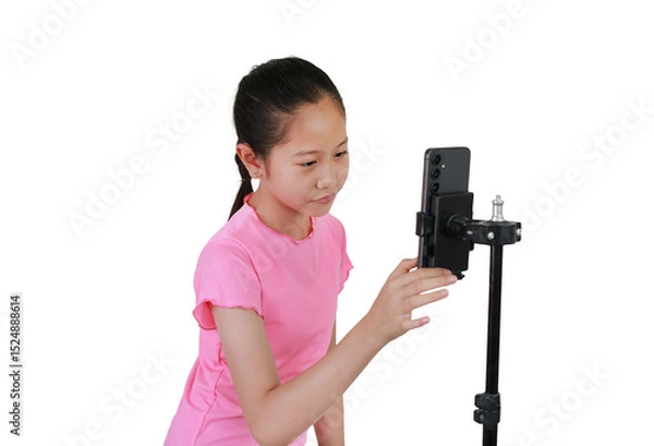 Obraz Asian young girl recording video blog on smartphone isolated on white studio background.