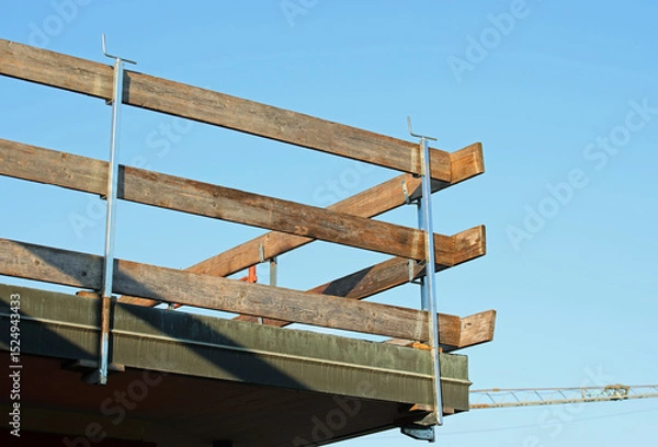 Fototapeta barrier with wooden planks installed on the roof for the protection of workers to avoid falls during the roof repair work