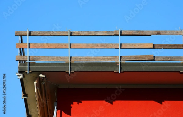 Fototapeta fall protection barrier with planks marks the work area on the roof