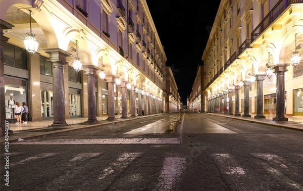 Fototapeta Night view of the street called VIA ROMA  in Turin City in Northern Italy with many arcades and large shop windows
