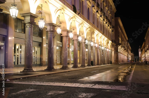 Fototapeta Night view of the road called VIA ROMA  in Turin City in Northern Italy with many arcades and shop windows