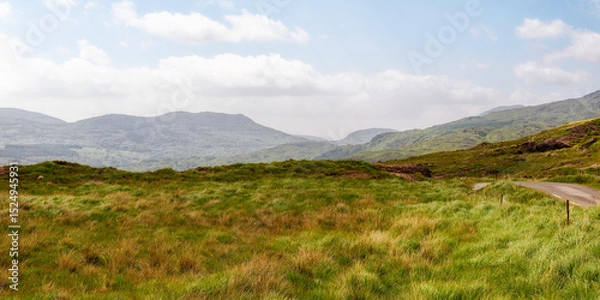 Fototapeta View of rural irish landscape, path through the gap of dunloe leading into the distance, county kerry.