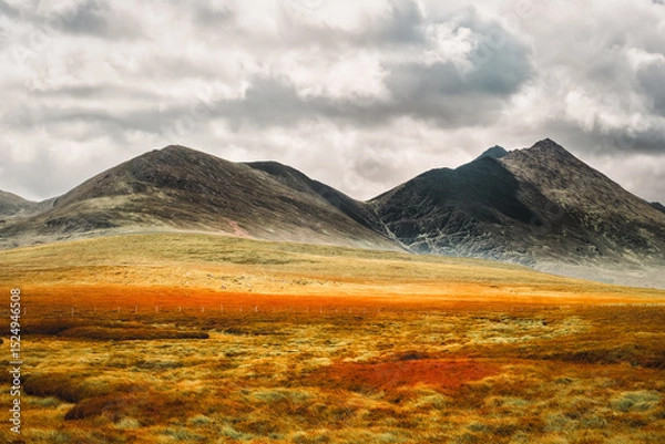 Fototapeta Scenic irish landscape view featuring mountain under a cloudy sky in County Kerry, Ireland.