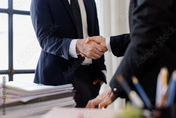 Obraz Happy business asian manager handshaking client at meeting. Smiling female hr hiring recruit at job interview, insurance agent, lawyer making contract deal at work with business handshake.