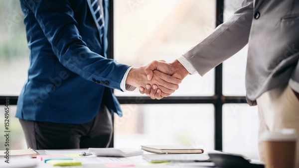 Obraz Two men shake hands in a business meeting