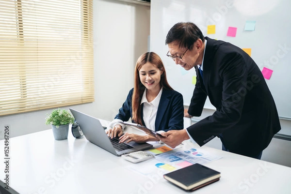 Obraz A man and a woman are working together on a laptop