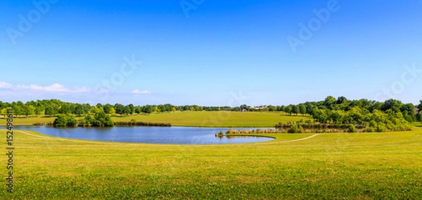 Fototapeta Wide Angle View of Public Park:  Wide angle view of a public park featuring a small lake in the center.