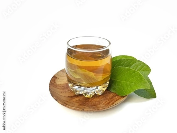 Fototapeta Guava leaf boiled water in glass and fresh guava leaves. Healthy drink lifestyle 