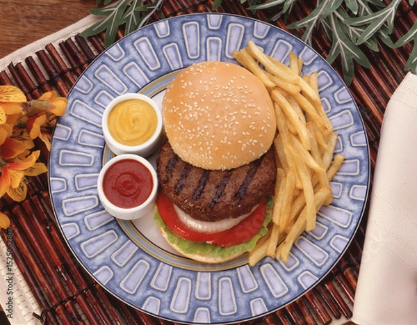 Obraz view from above of hamburger potato french fries and sauces dish.
