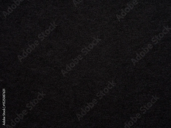 Fototapeta In the quietude of night, a black textured surface whispers of elegance and understated complexity