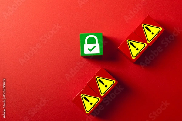 Obraz A green wooden block with a secure padlock icon protected from red blocks with warning symbols. Concept for cybersecurity, threat defense, data protection, firewall,risk management,security system.