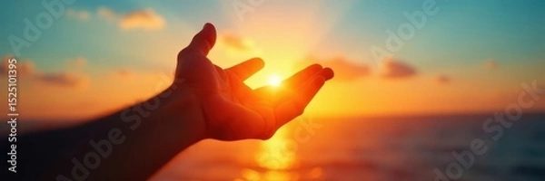 Obraz Silhouetted hand outstretched towards a setting sun, azure sky backdrop , nature, outdoor