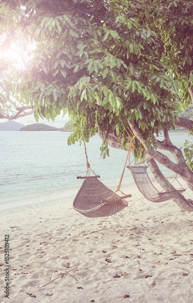 Fototapeta Hammocks on the beach of a tropical island, color toning applied, Philippines.