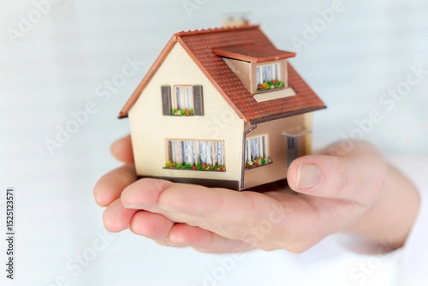 Obraz House in human hands on a white background...